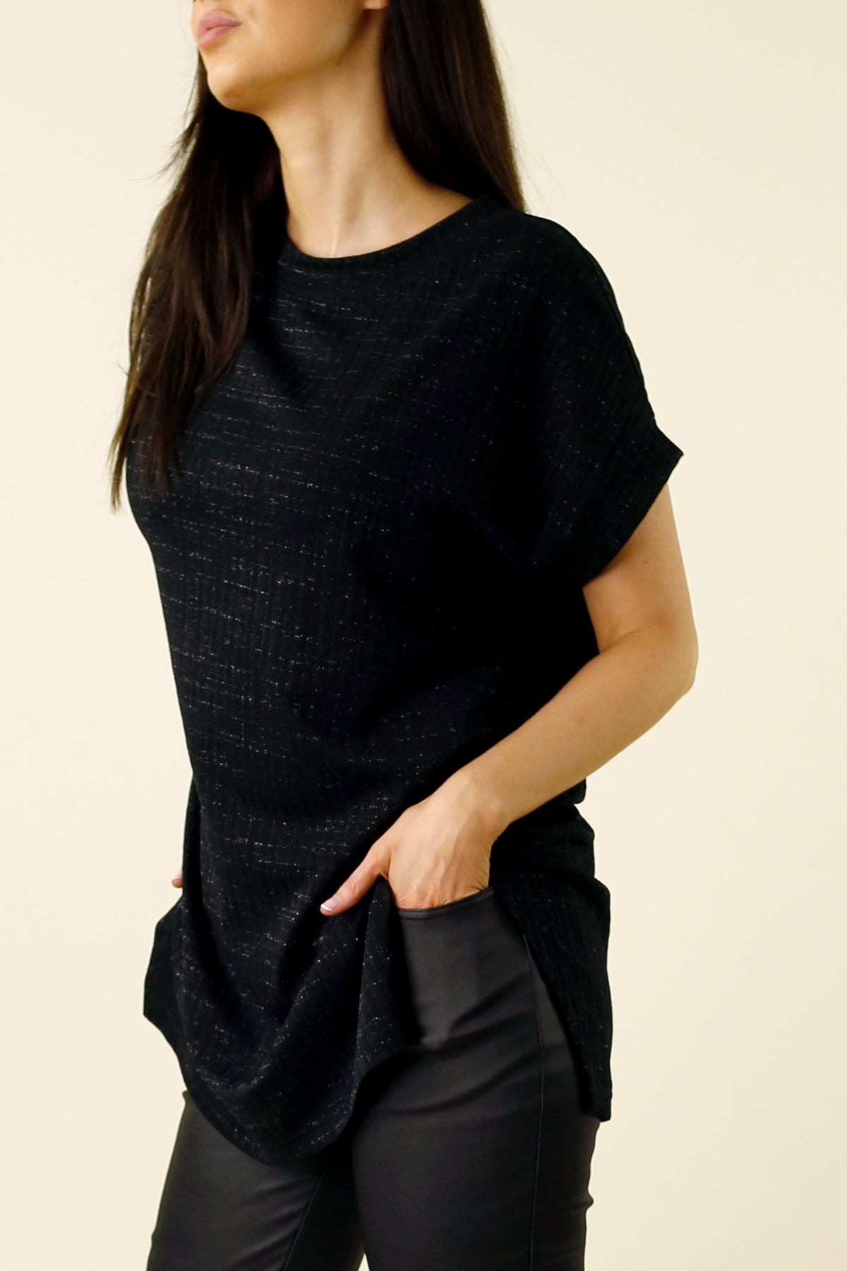 Black Lurex Twinkle Vest in an elevated oversized drape, subtle sparkle rib, styled with tailored trousers.