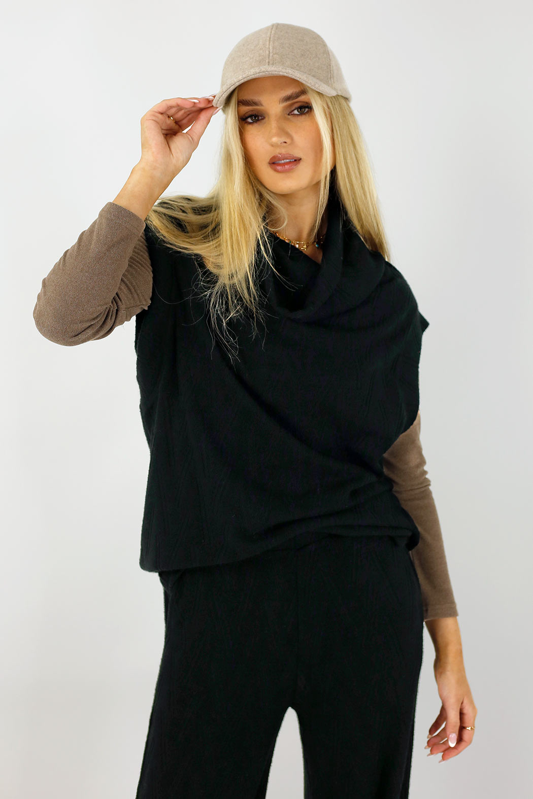 Black Cosy Cowl Vest layered over a brown top, the cowl neckline and chevron knit in effortless, elevated styling.