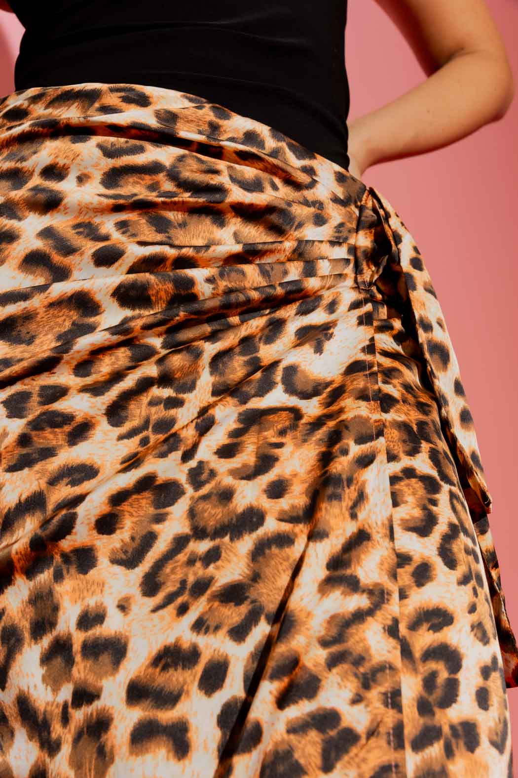 Close-up front view of the animal print knot front skirt, with an effortless waist knot and sophisticated leopard drape.