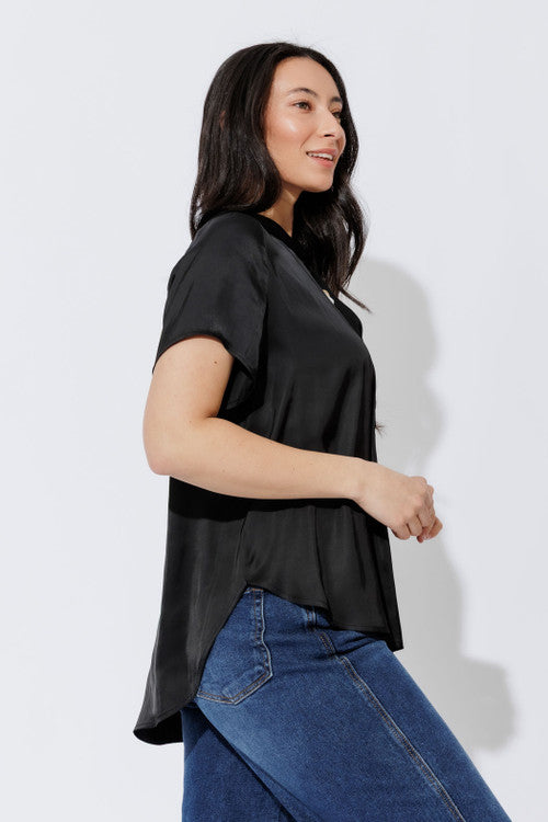 Black silky tie collar shirt in relaxed side profile, short sleeves and soft drape styled with denim.
