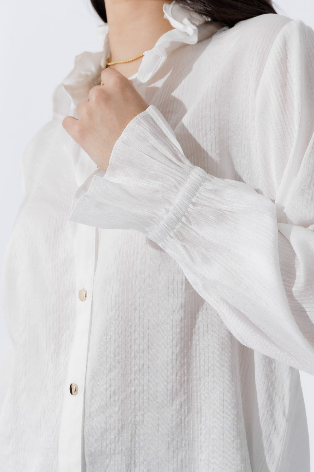 White Frill Shirt front‑on, highlighting its frill collar, button‑up front and elastic cuffs for a sophisticated, modern vibe.