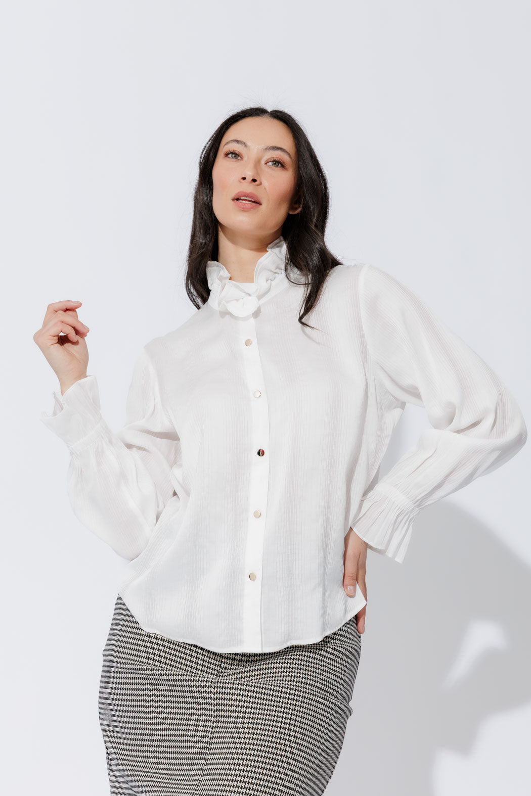 White Frill Shirt presented front‑facing on a mannequin, modern style with frill collar, button‑up front and elastic cuffs.