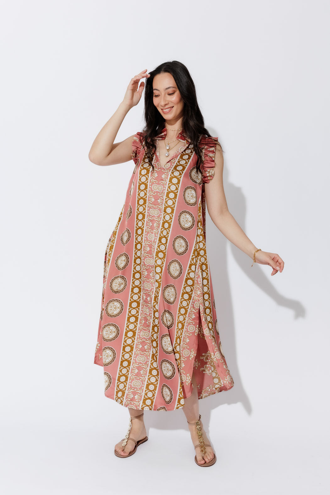 Coral Ruffle Maxi Dress in a full-length front view, patterned A-line silhouette and ruffled neckline styled with sandals.