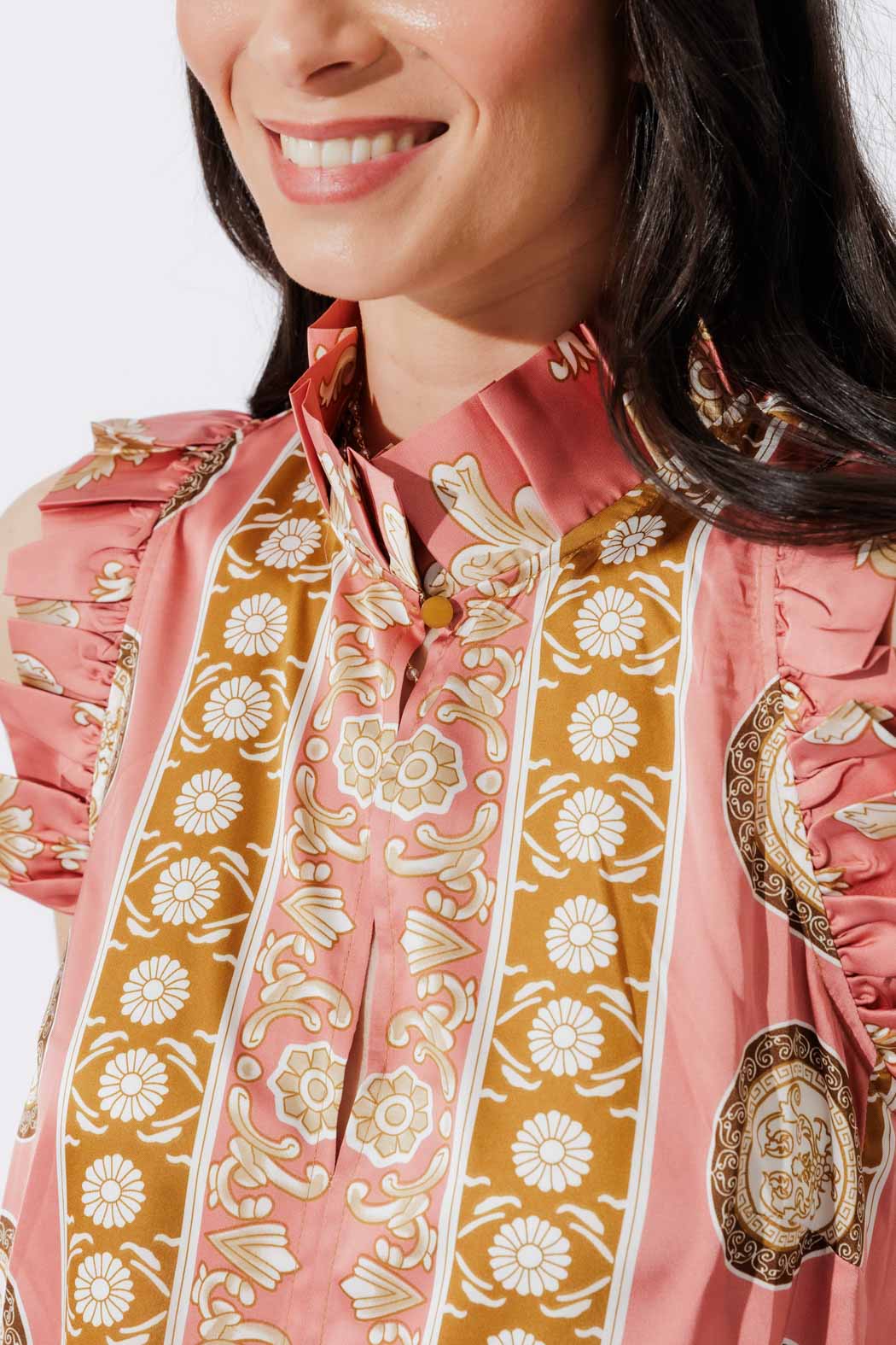 Close-up of the Coral Ruffle Maxi Dress neckline, with ruffled collar, tie detail and sophisticated gold floral print.