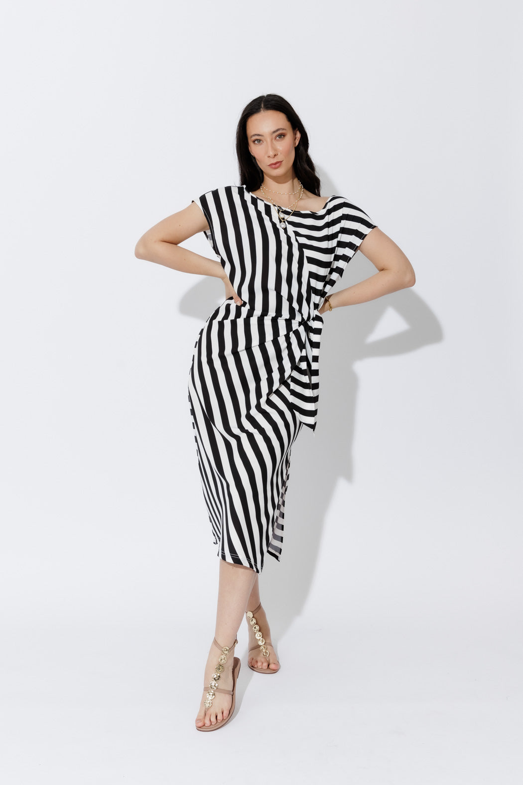 Bold Stripe Harlow Dress in fluid black-and-white stripes with a tie-front detail and modern, versatile silhouette.