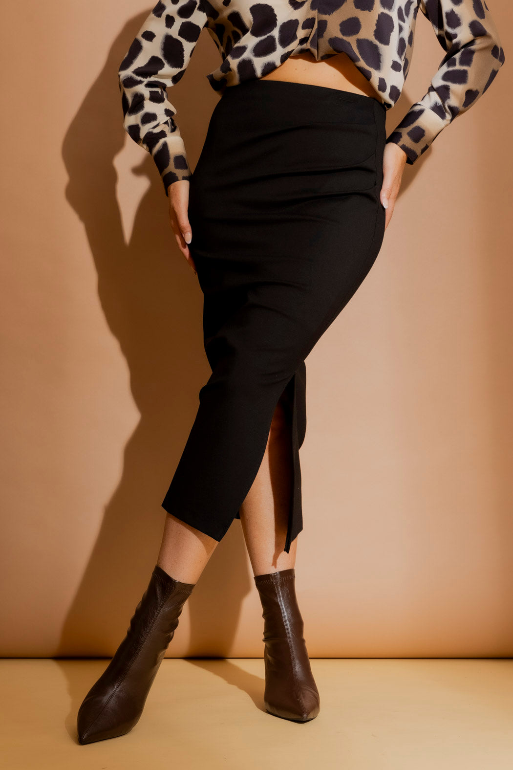 Effortless Black Ponte Ruched Miracle Skirt, styled with leopard top and pointed boots, side ruching and split.