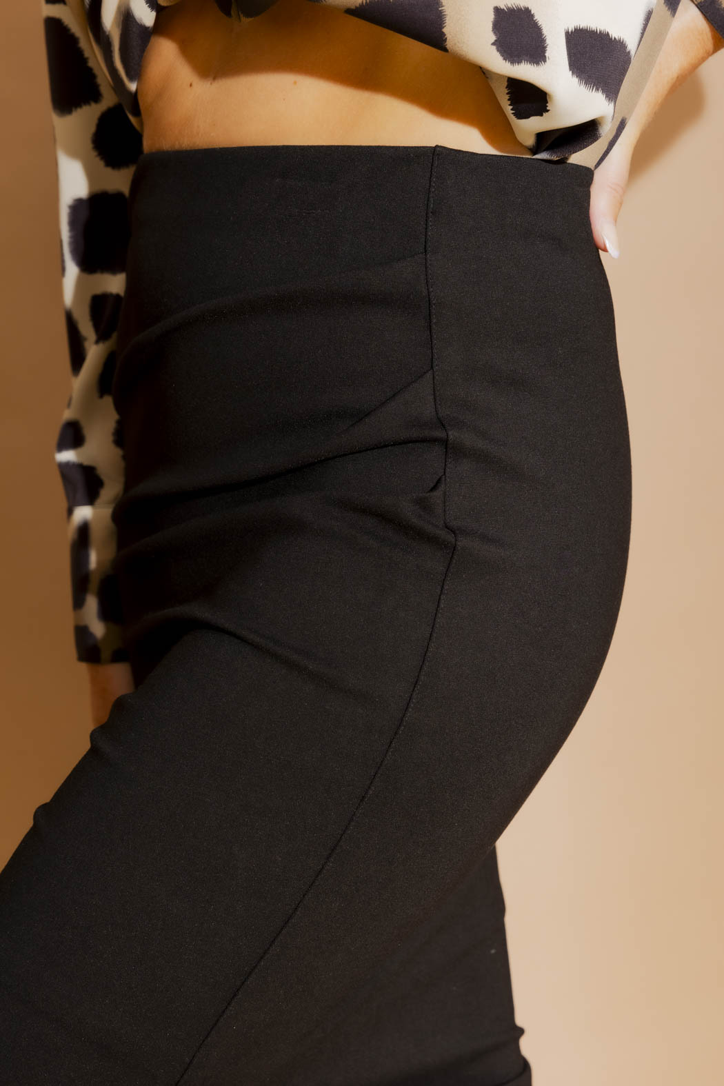 Side view of the Black Ponte Ruched Miracle Skirt, showcasing sculpted ruching and a sleek stretch silhouette.