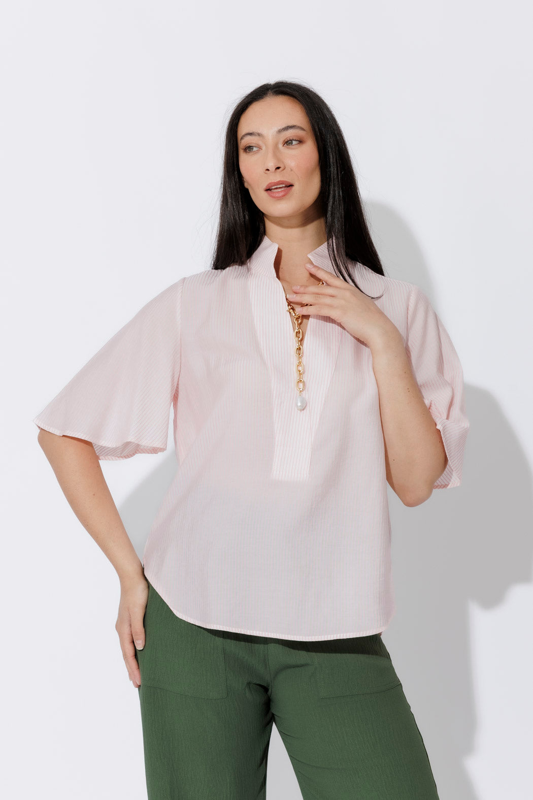 Effortless Pink Pinstripe Fluted Blogger Shirt with fluted short sleeves, styled with green trousers.