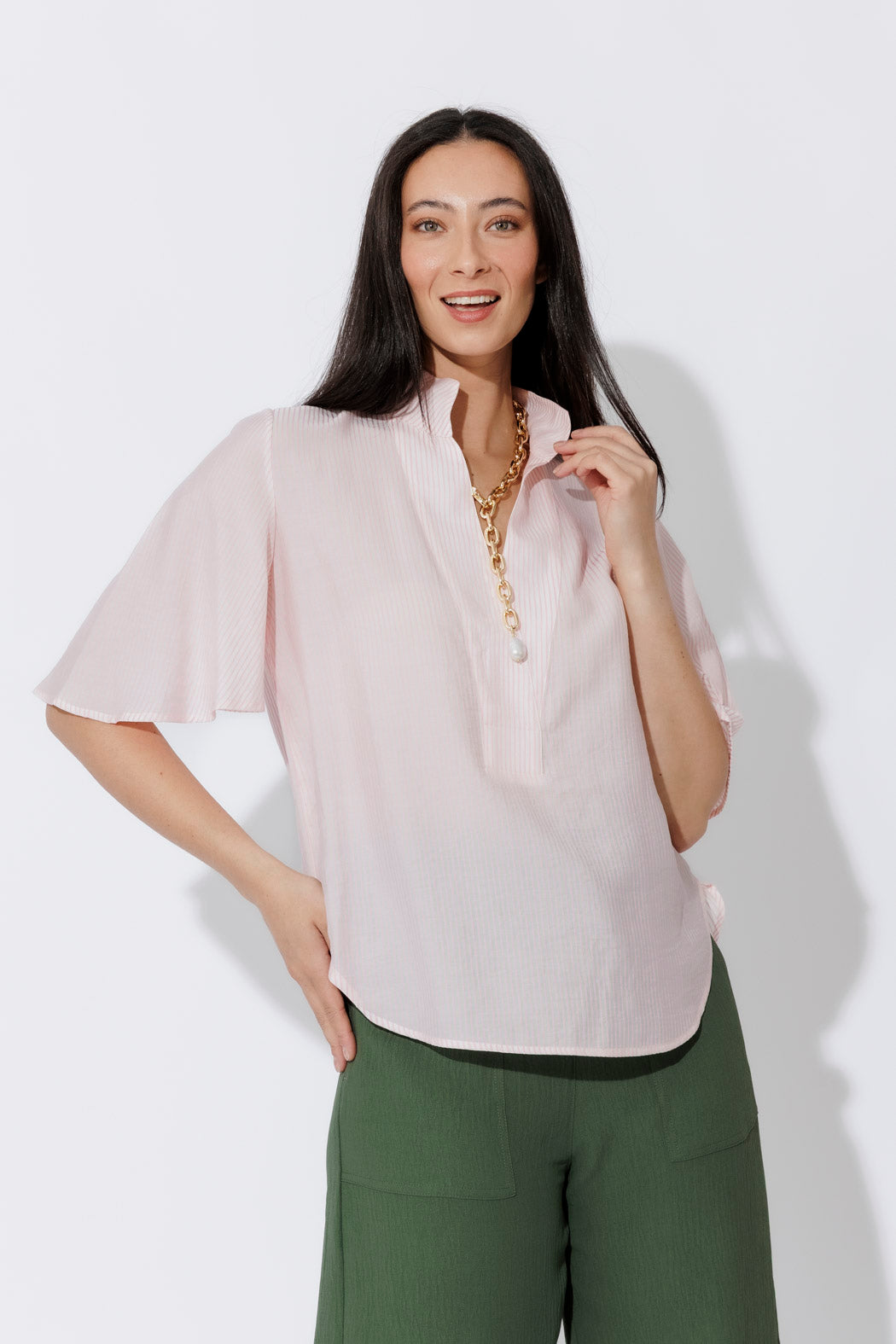 Effortless Pink Pinstripe Fluted Blogger Shirt in a relaxed short-sleeve cut, styled with olive trousers and a gold chain.