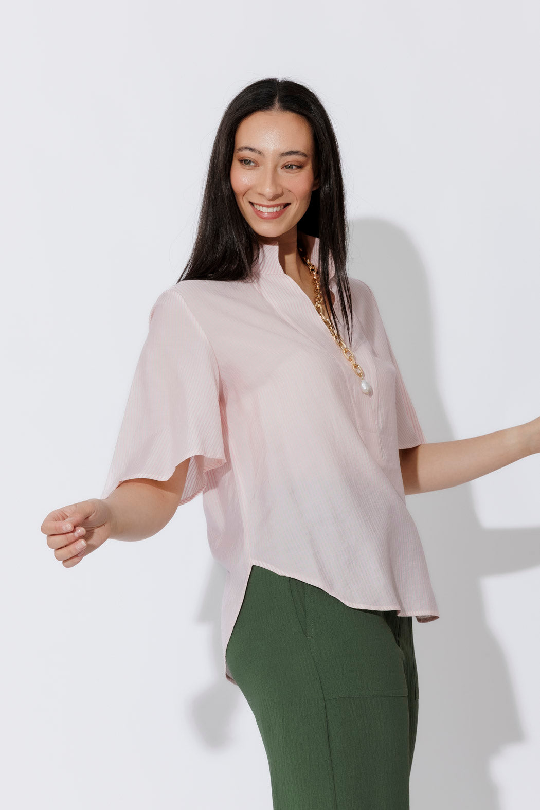 Pink Pinstripe Fluted Blogger Shirt in relaxed cotton, styled with green trousers and a gold chain for effortless polish.