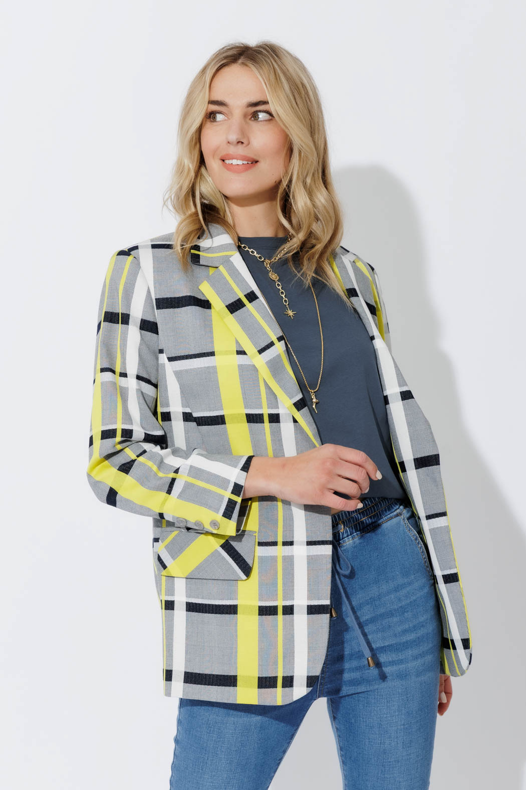 Neon Check Boyfriend Blazer in grey and neon yellow plaid, styled open over denim for an effortless, elevated look.