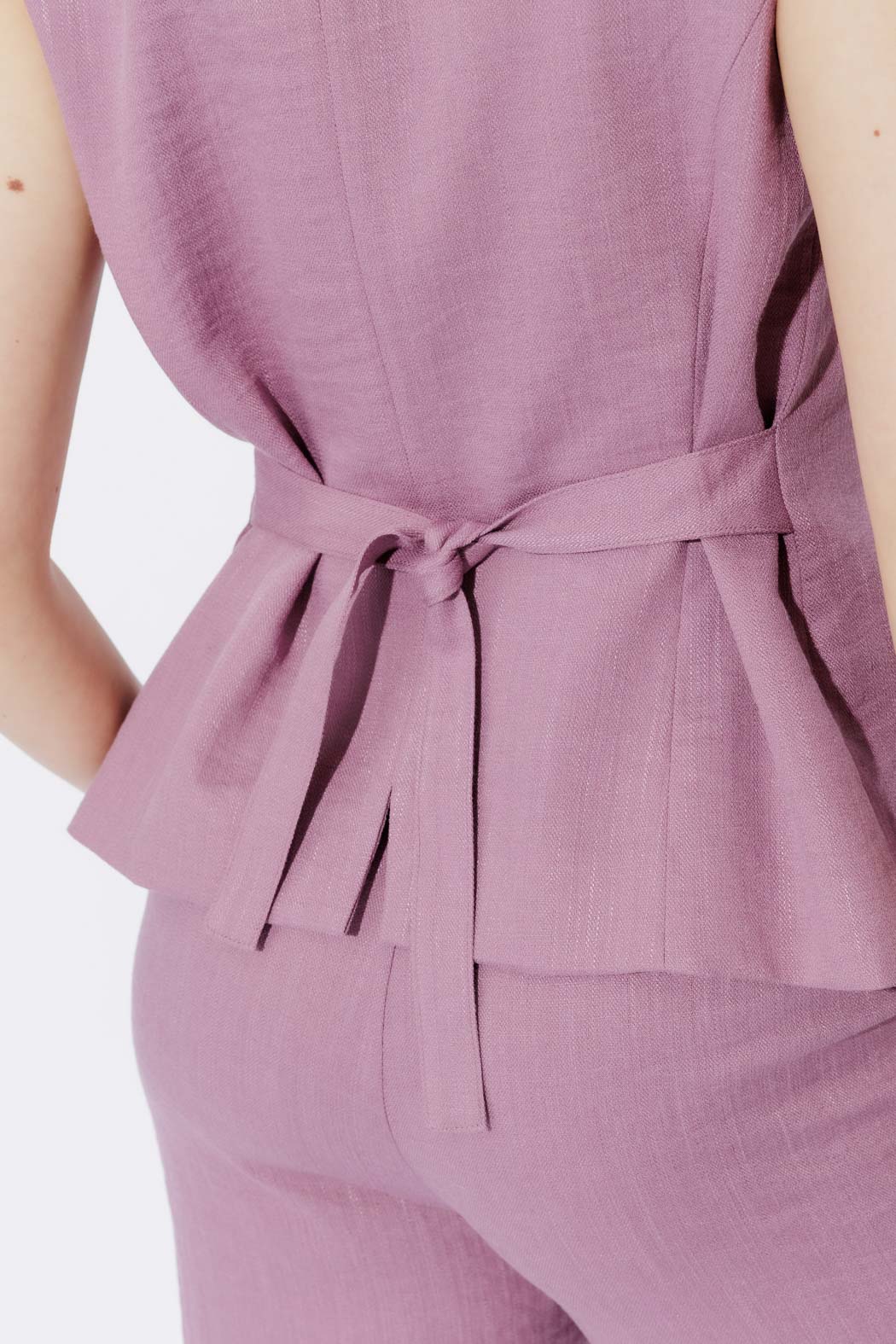 Mauve Berry Lyocell Vest with knotted self-tie waist, fluid peplum hem and refined suiting texture.