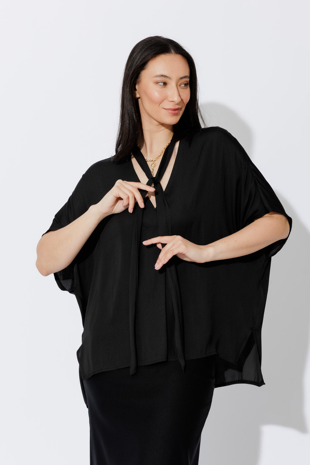 Model wears the Black Tie Bondi Top, oversized silhouette with V‑neck, long ties and stepped hem draping effortlessly.