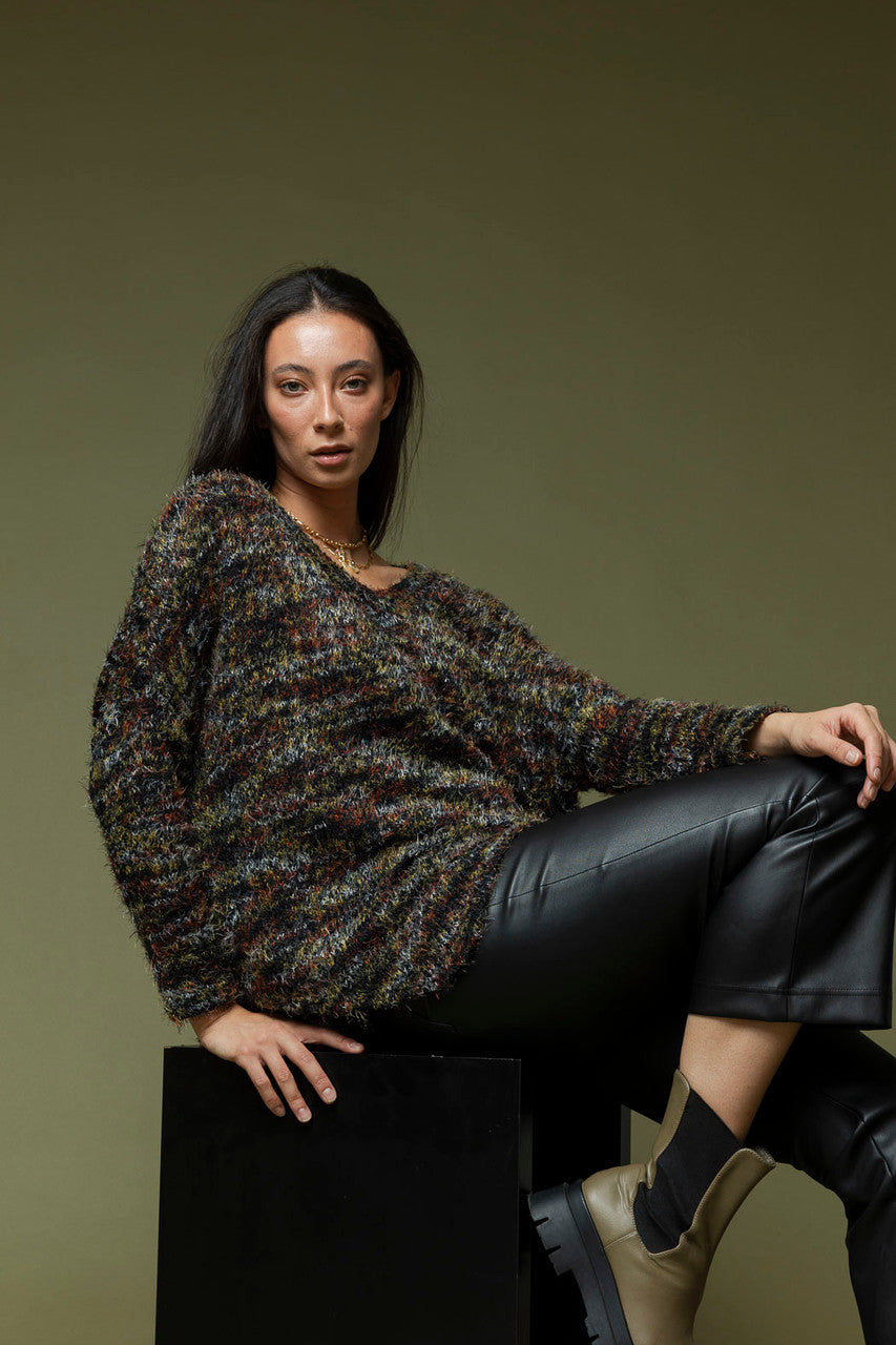 Black speckle fluffy V-neck jumper in a relaxed silhouette, styled with leather trousers for an elevated, effortless look.
